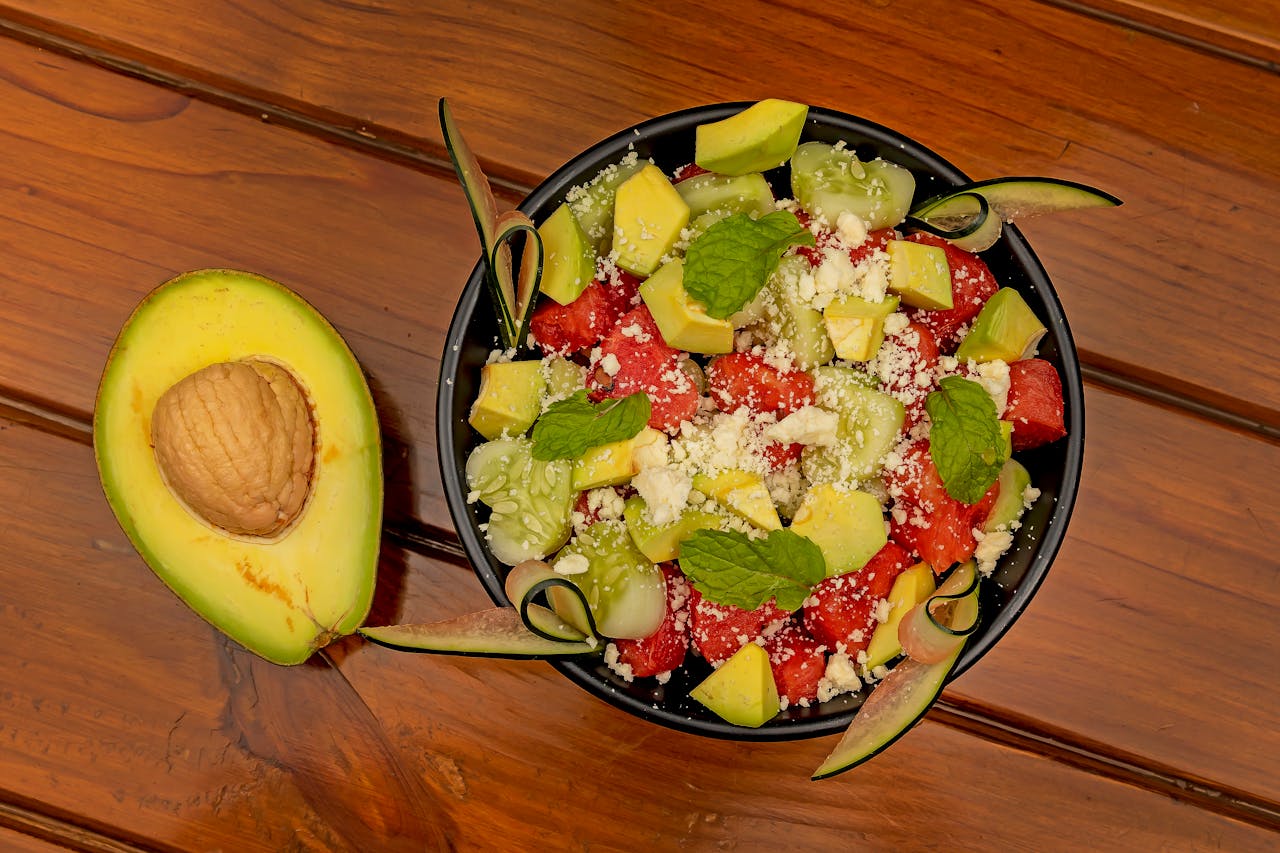 Vibrant salad with avocado, watermelon, cucumber, and cheese.
